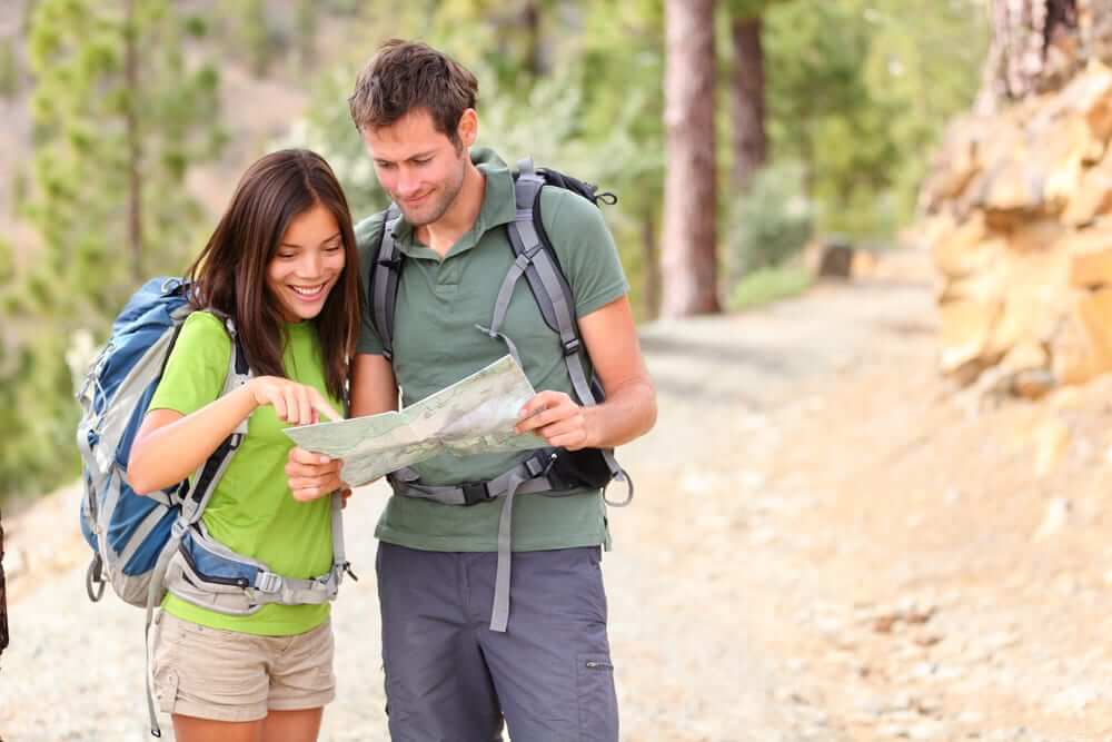 2 people on a hike looking at a map
