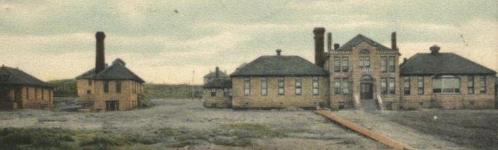 an old two story building, the original hospital