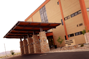 exterior of specialty clinic building with mountains in the background