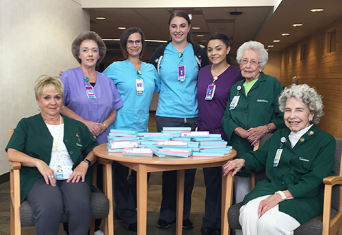 7 women at a table with boxes on it