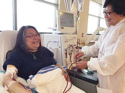nurse helping woman with dialysis